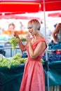 Woman tasting grapes in market