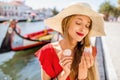 Woman tasting portuguese dessert in Aveiro city