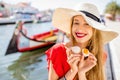 Woman tasting portuguese dessert in Aveiro city