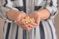 Woman with tasty cashew nuts, closeup