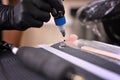 Woman tattoo artist pouring ink