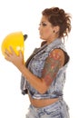 Woman tattoos construction hold hat