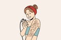 Woman tattoos hand on own and smiles, offering to use services of professional tattoo artist Royalty Free Stock Photo