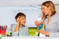 Woman teach boy with autism clock and hours Royalty Free Stock Photo