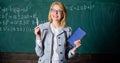 Woman teacher with book in front of chalkboard think about work. Teach cognition processing strategies. Cognition