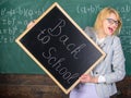 Woman teacher formal suit holds blackboard inscription back to school. Teacher informs about start of education. Lady Royalty Free Stock Photo