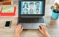 Woman teacher having a video call with multiracial students during isolation quarantine - Group of people chatting online -