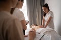 Woman teacher helping student training to become masseuse, health wellness massage training Royalty Free Stock Photo