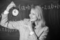 Woman teacher hold alarm clock. Girl school lecturer. What time is it. Lessons schedule. Welcome teacher school year