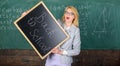 Woman teacher holds blackboard inscription back to school. Looking committed teacher complement qualified workforce