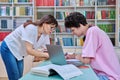 Woman mentor teaching male student in college library, exam preparation Royalty Free Stock Photo