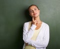 Woman, teacher thinking and chalkboard for education, learning information and teaching or knowledge. Young professor Royalty Free Stock Photo