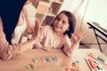 Woman and Girl with Colored Toy Numbers on Table.