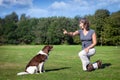 Woman teaches her dog a command Royalty Free Stock Photo