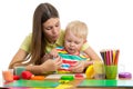 Woman teaches kid boy handcraft at kindergarten or playschool Royalty Free Stock Photo