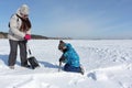 Woman teaching boy sawing snow to build an igloo, Novosibirsk, Russia
