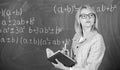 Woman teaching near chalkboard in classroom. Effective teaching involve acquiring relevant knowledge about students Royalty Free Stock Photo