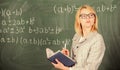 Woman teaching near chalkboard in classroom. Effective teaching involve acquiring relevant knowledge about students