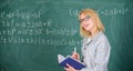 Woman teaching near chalkboard in classroom. Qualities that make good teacher. Effective teaching involve prioritizing Royalty Free Stock Photo