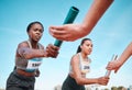 Woman, teamwork and baton in relay, running competition or sports fitness on stadium track. Active people or athlete Royalty Free Stock Photo