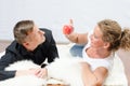 Woman teasing man with apple