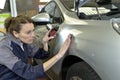 Woman technician working in a car shop