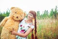 Woman with a Teddy bear in nature Royalty Free Stock Photo