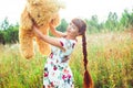 Woman with a Teddy bear in nature Royalty Free Stock Photo