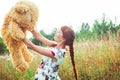 Woman with a Teddy bear in nature Royalty Free Stock Photo