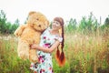 Woman with a Teddy bear in nature Royalty Free Stock Photo