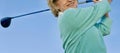 Woman teeing off with her driver golf club Royalty Free Stock Photo