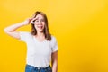 Woman teen smile standing wear t-shirt showing finger making v-sign symbol near eye Royalty Free Stock Photo