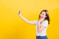 Woman teen smiling standing wear t-shirt making selfie photo, video call on smartphone Royalty Free Stock Photo