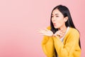 Woman teen standing blowing kiss air something on palm Royalty Free Stock Photo