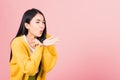 Woman teen standing blowing kiss air something on palm Royalty Free Stock Photo