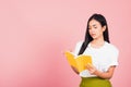 Woman teenage smiling holding a book and reading Royalty Free Stock Photo