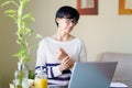 Woman teleworking from home with wrist pain having a massage to rest.