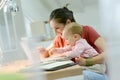 Woman teleworking and taking care of her baby Royalty Free Stock Photo