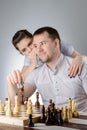The woman tells the man's ear how to play chess Royalty Free Stock Photo