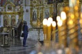 A woman in a temple. Interior of the Orthodox Church. A person prays in a church.