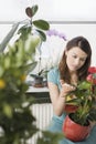 Woman tending plants in home