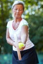 Woman, tennis racket and ball for exercise outdoor for sport workout, game play or match. Mature, female person and Royalty Free Stock Photo