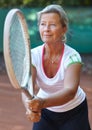 Woman, tennis racket and ready serve on court for outdoor sport, competition or game match. Senior, female person and Royalty Free Stock Photo