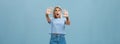 Woman terrified screaming and asking stop. Portrait of shocked panicking troubled blonde female in denim shorts and