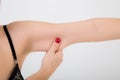Woman testing the flabby muscle under her arm Royalty Free Stock Photo