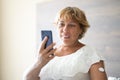 Woman Testing Glucose Level With Continuous Glucose Monitor