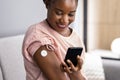 Woman Testing Glucose Level With Continuous Glucose Monitor