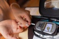 Woman testing for high blood sugar. Woman holding device for measuring blood sugar. Royalty Free Stock Photo