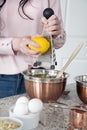 Woman zesting a lemon in the kitchen Royalty Free Stock Photo