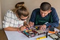 Woman testing motherboard and man repairing it Royalty Free Stock Photo